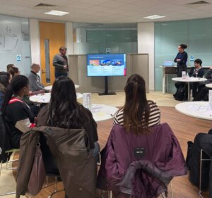 UTC College students sitting in the audience listening to colleagues talk about Alfred H Knight